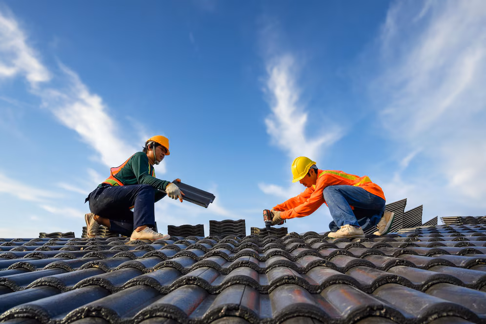 asian male roof installer asian construction workers roof work using drill bit fix ceramic cement roofing screws construction site 140555 1225